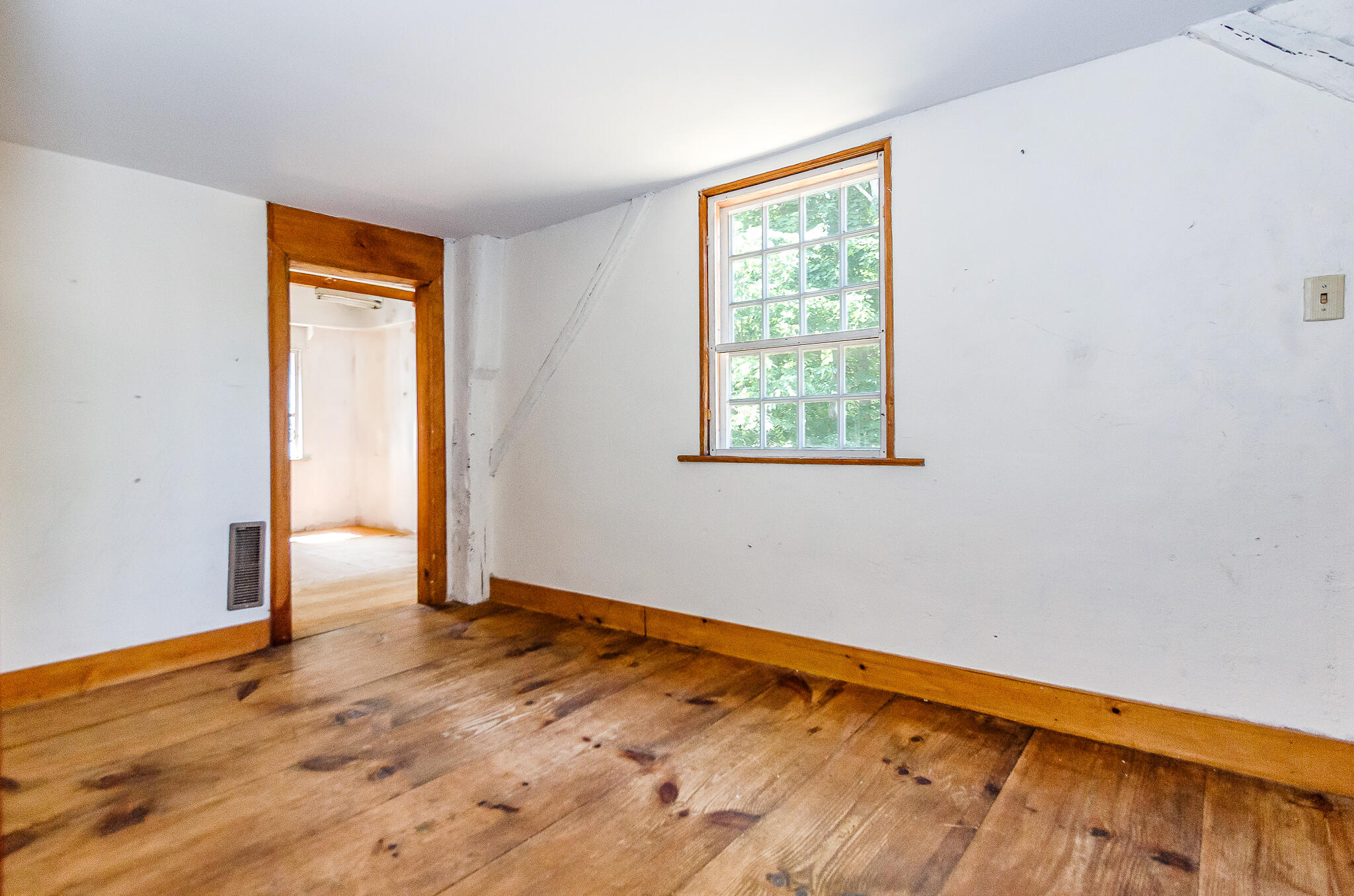 4701 Falmouth Road Cotuit, MA 02635 - Photo 21 of 39 a view of an empty room with wooden floor and a window