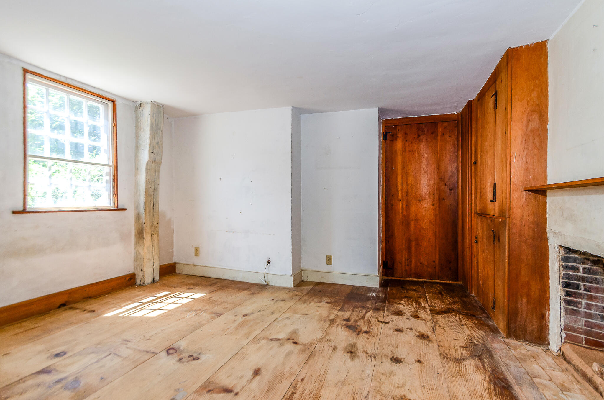 4701 Falmouth Road Cotuit, MA 02635 - Photo 23 of 39 a view of an empty room with wooden floor and a window