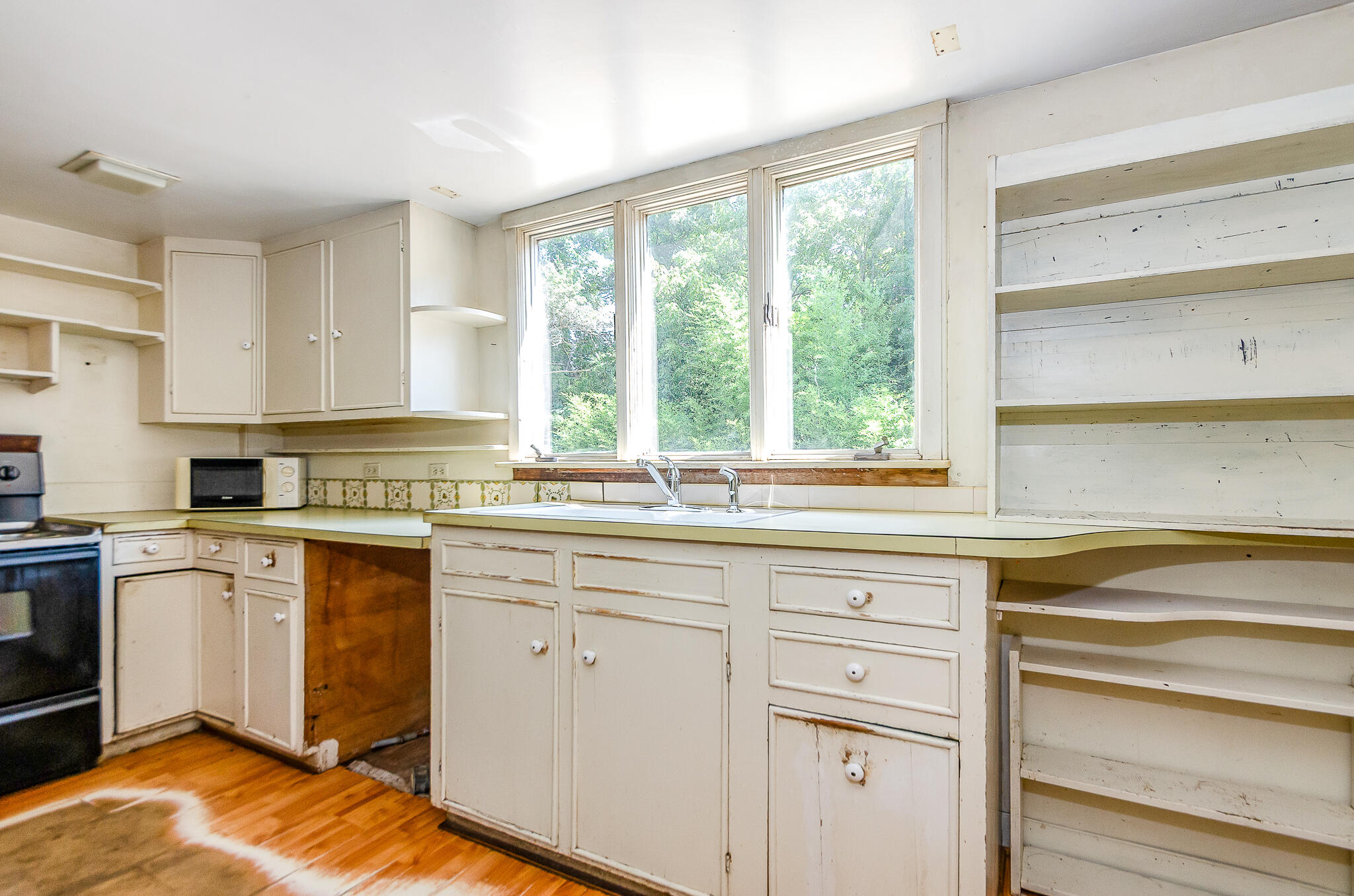 4701 Falmouth Road Cotuit, MA 02635 - Photo 26 of 39 a kitchen with granite countertop white cabinets and white appliances