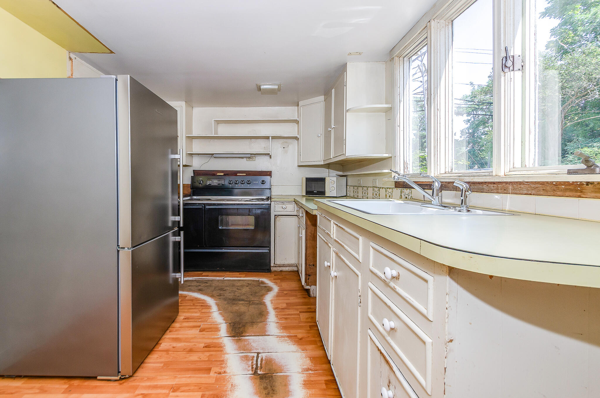 4701 Falmouth Road Cotuit, MA 02635 - Photo 27 of 39 a kitchen with a sink stove and refrigerator