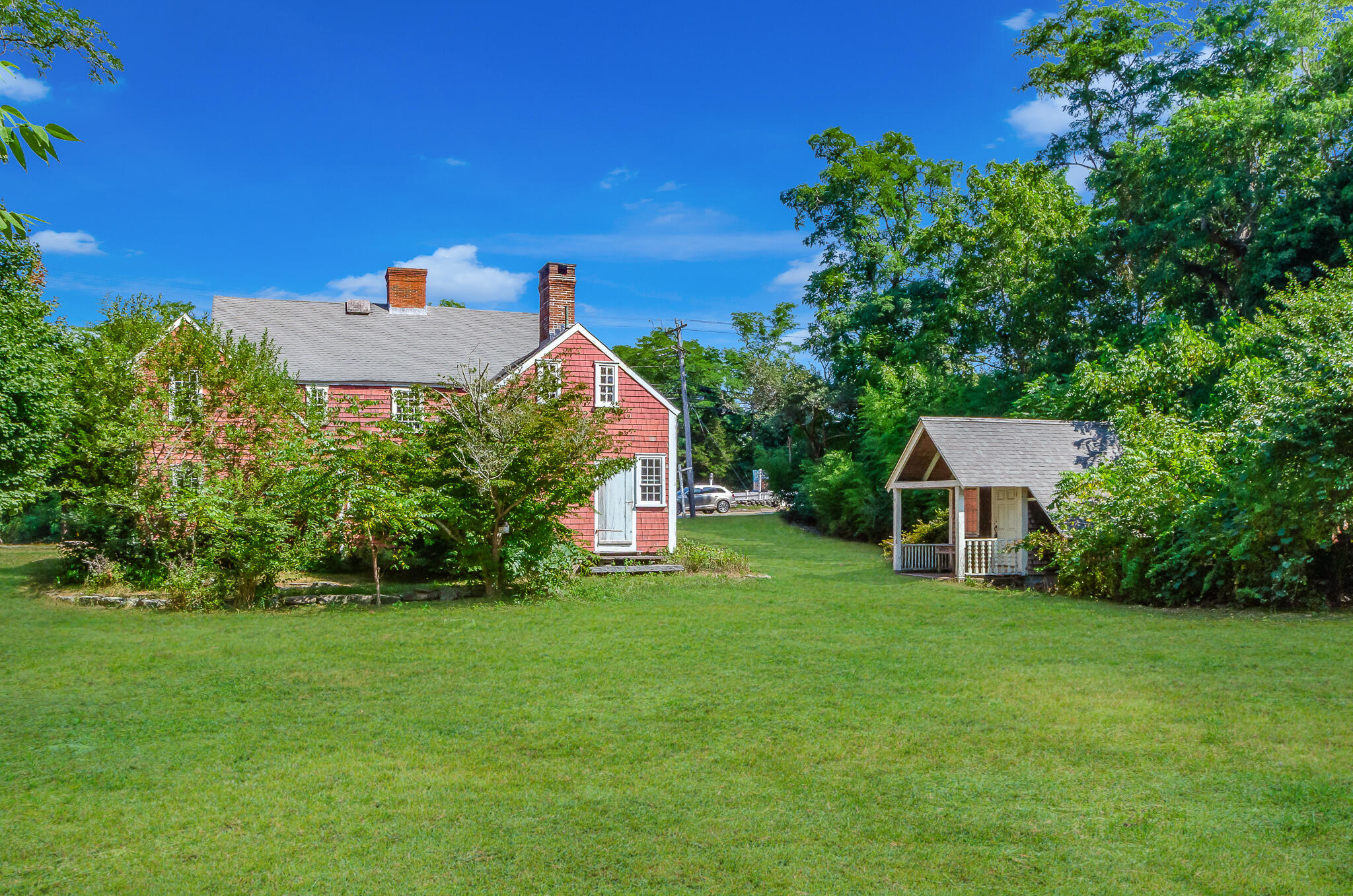 4701 Falmouth Road Cotuit, MA 02635 - Photo 4 of 39 a front view of a house with a yard