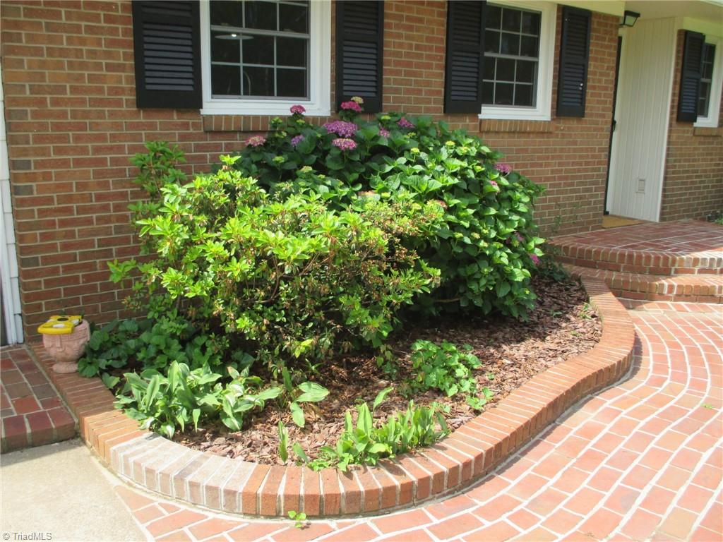 409 Price Road Lexington, NC 27295 - Photo 26 of 30 BRICK ENTRY WITH MATURE PLANTINGS