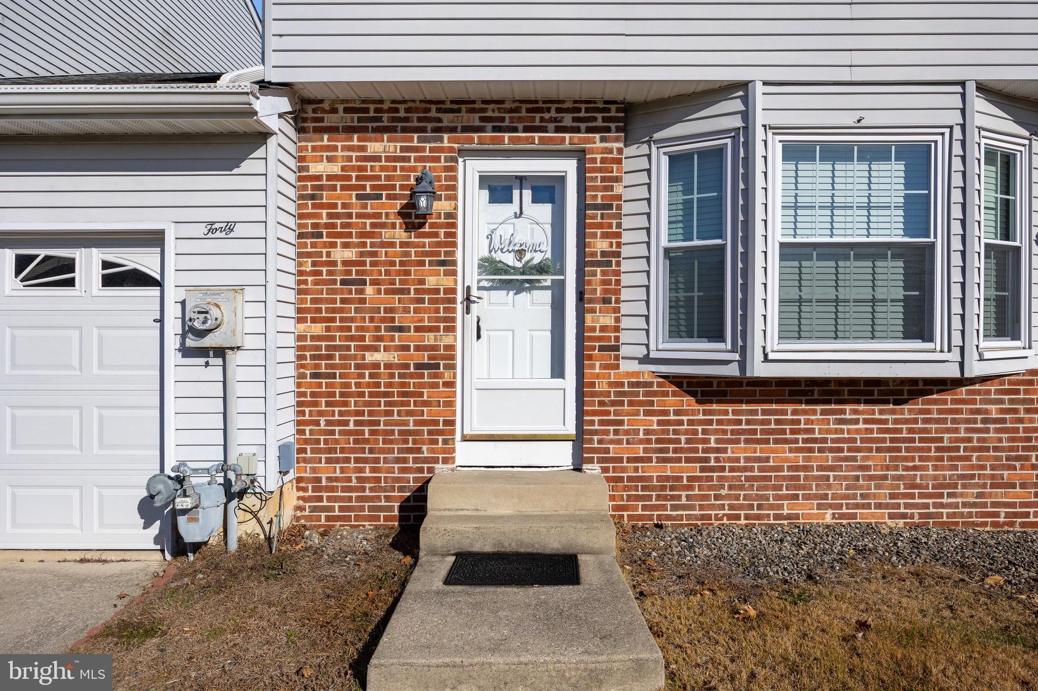 40 Blue Jay Drive Clementon, NJ 08021 - Photo 4 of 27 a view of a brick house with large windows