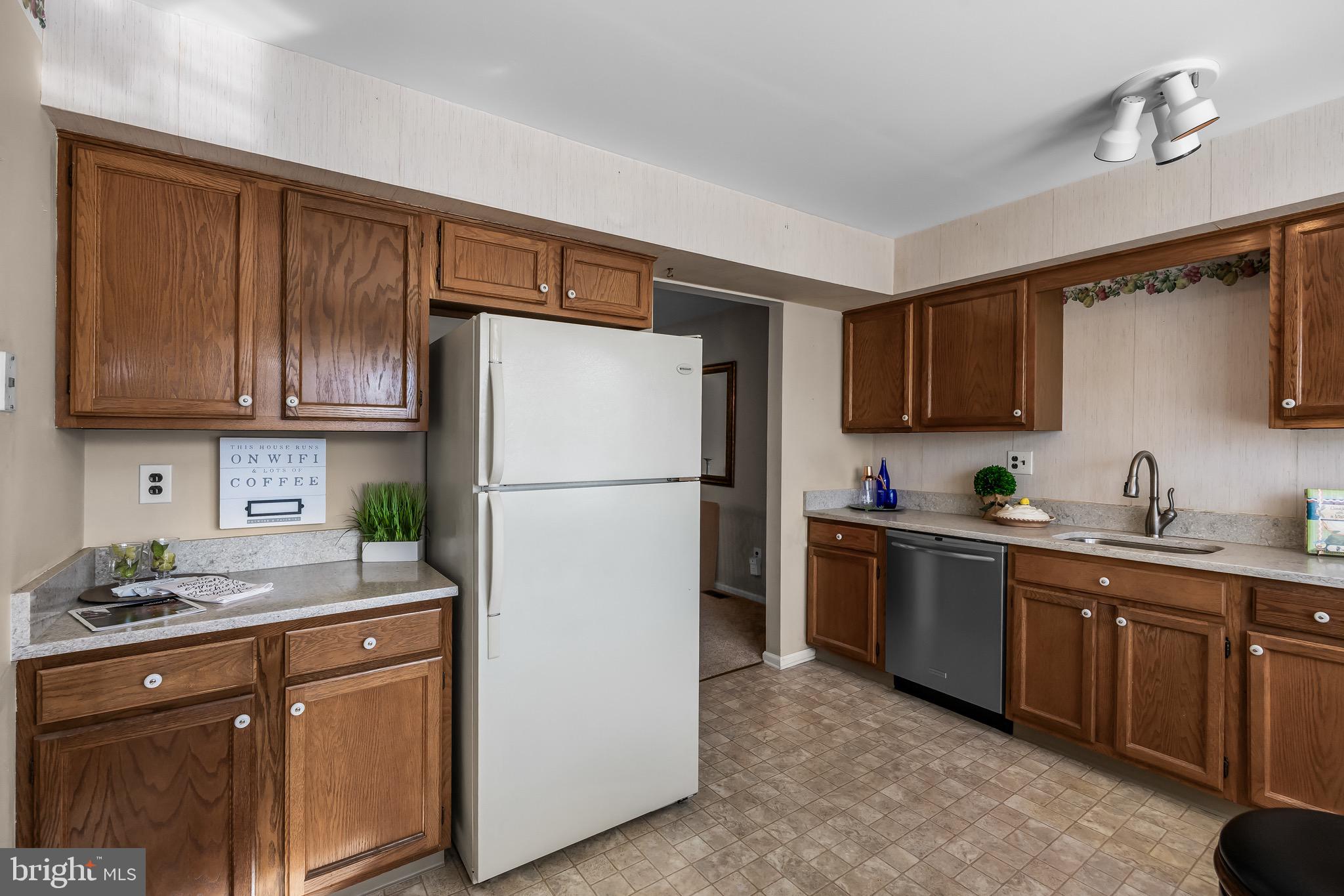 40 Blue Jay Drive Clementon, NJ 08021 - Photo 6 of 27 a kitchen with stainless steel appliances granite countertop a refrigerator a sink dishwasher a stove top oven a refrigerator with cabinets and wooden floor