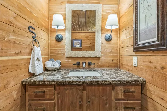 a kitchen with stainless steel appliances granite countertop a refrigerator stove a sink and dishwasher with wooden floor