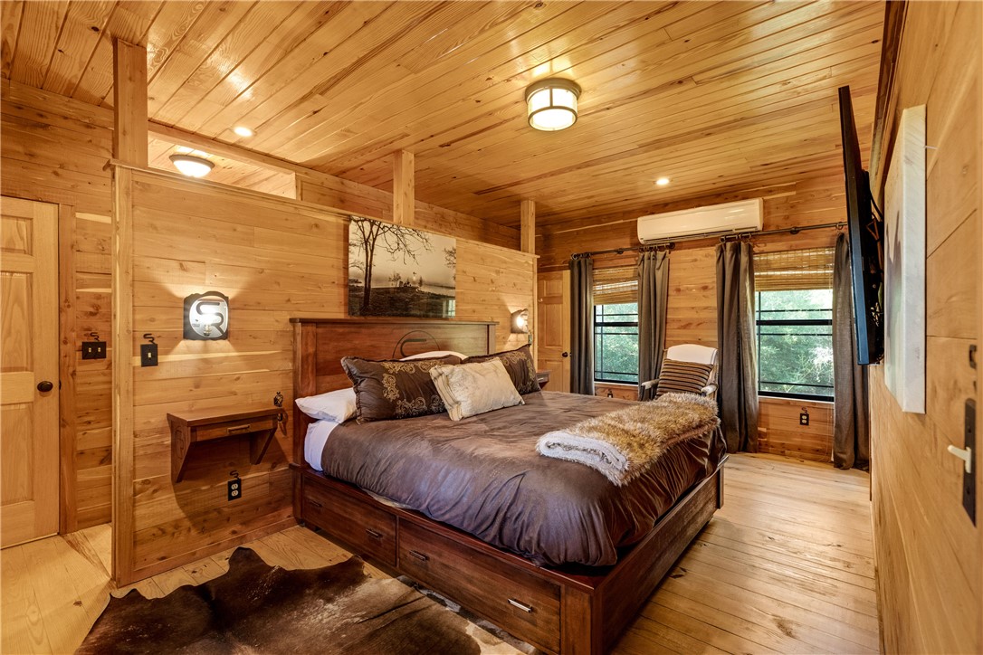 20650 Farm To Market 2154 Navasota, TX 77868 - Photo 31 of 35 a spacious bedroom with a bed and wooden floor