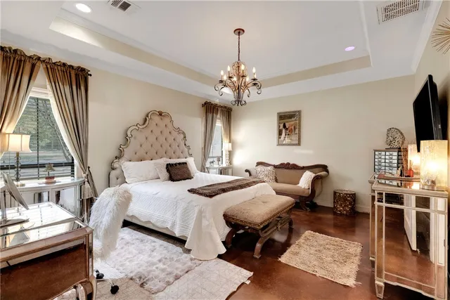 a bathroom with a double vanity sink a mirror a window and a bathtub