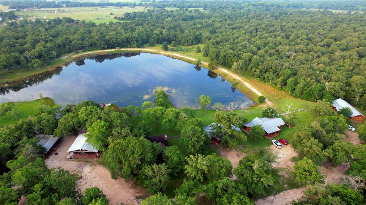 20650 Farm To Market 2154 Navasota, TX 77868 - Photo 6 of 35 a view of a lake with a yard and mountain