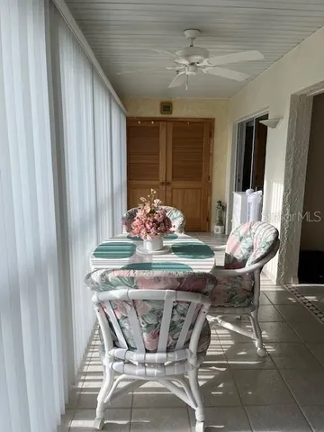 a dining room with furniture and a floor to ceiling window