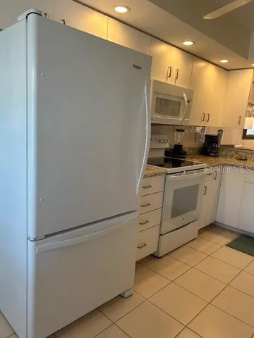 a work room with furniture and a large window