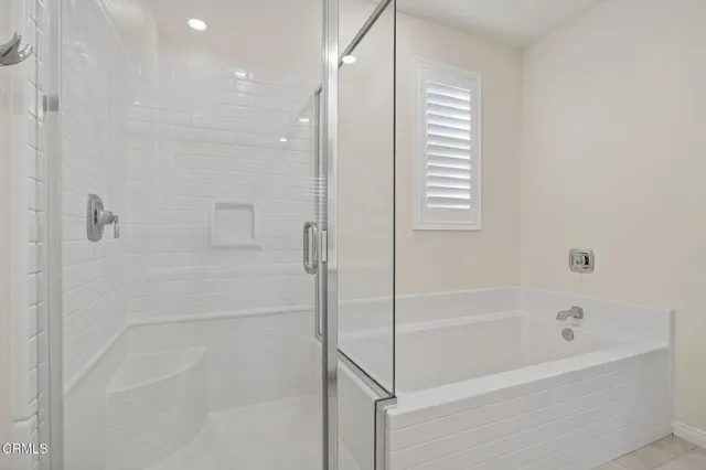 a view of a bathroom with a tub and shower