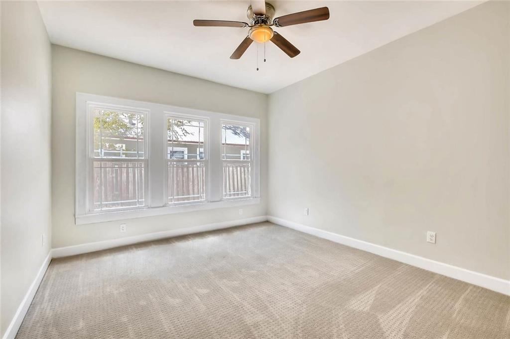 906 East 38th 1/2 Street Austin, TX 78751 - Photo 18 of 28 Bedroom number two has neutral carpet and a row of windows.