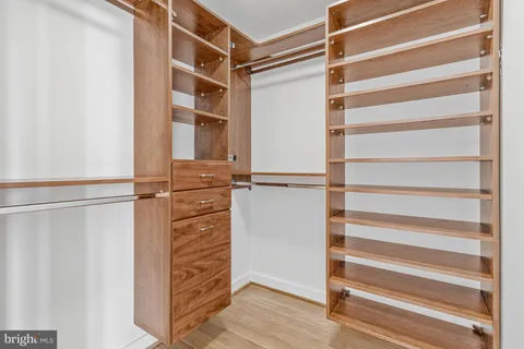 a view of walk in closet with empty racks