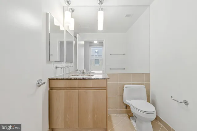 a bathroom with a toilet sink and mirror
