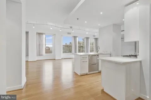 a large kitchen with stainless steel appliances a large counter top and a stove