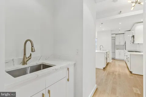 a view of a kitchen with sink and refrigerator