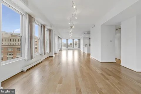 a view of an empty room and wooden floor