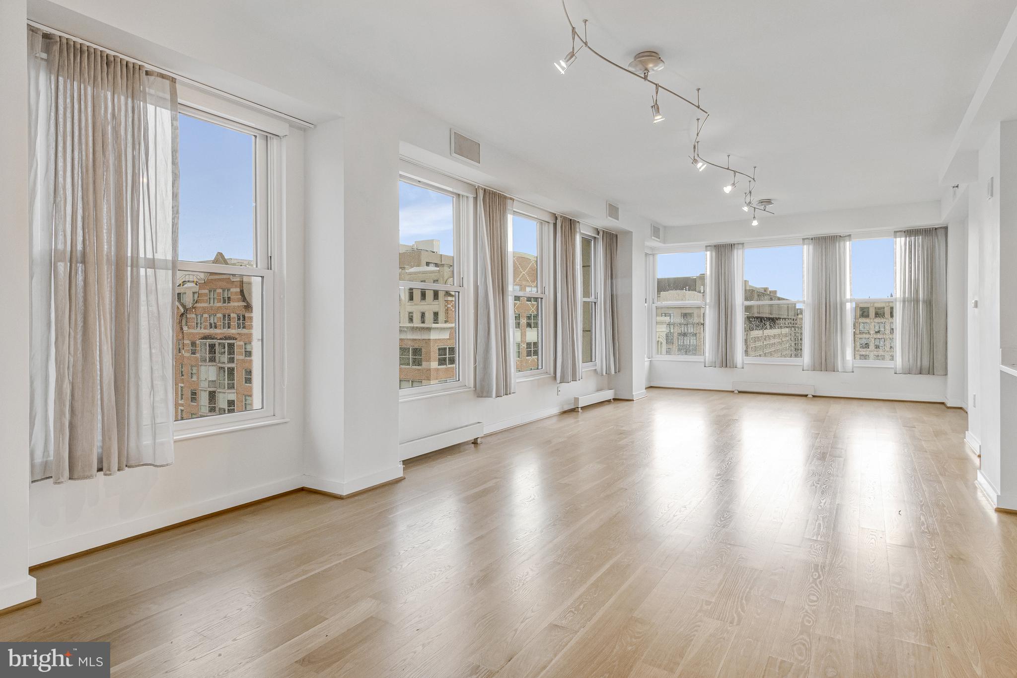 675 E Street Northwest, Unit 900 Washington, DC 20004 - Photo 32 of 40 a view of an empty room with wooden floor and a window