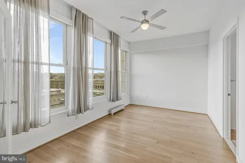 a view of an empty room and wooden floor