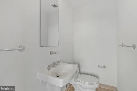 a view of a room with wooden floor and door