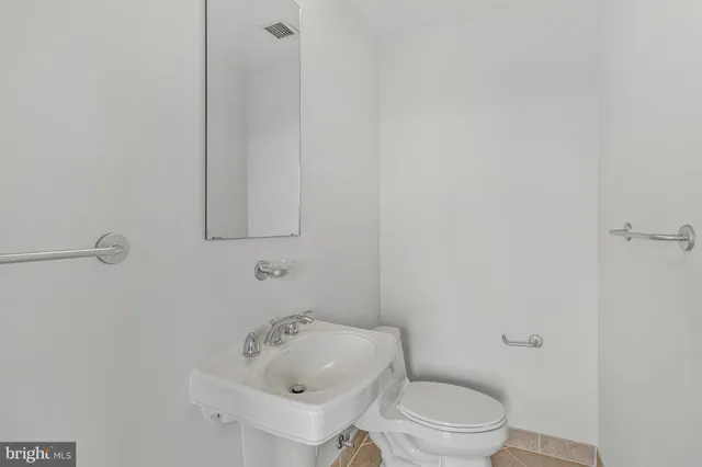 a view of a room with wooden floor and door