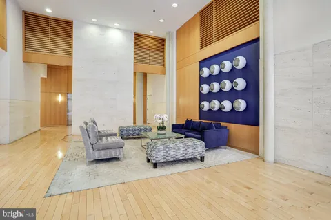 a spacious bedroom with a bed and wooden floor