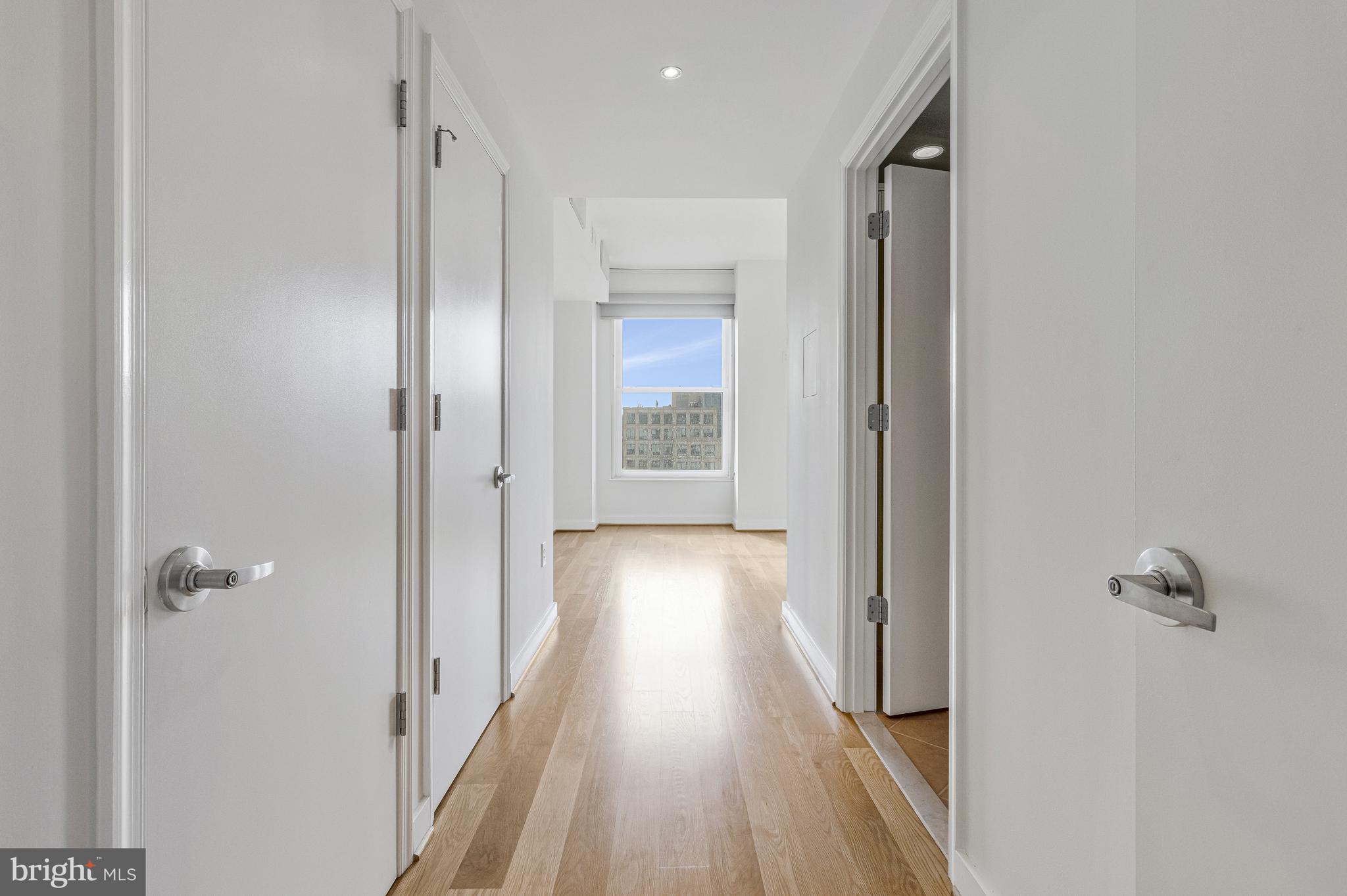 675 E Street Northwest, Unit 900 Washington, DC 20004 - Photo 7 of 40 a view of a hallway with wooden floor and closet