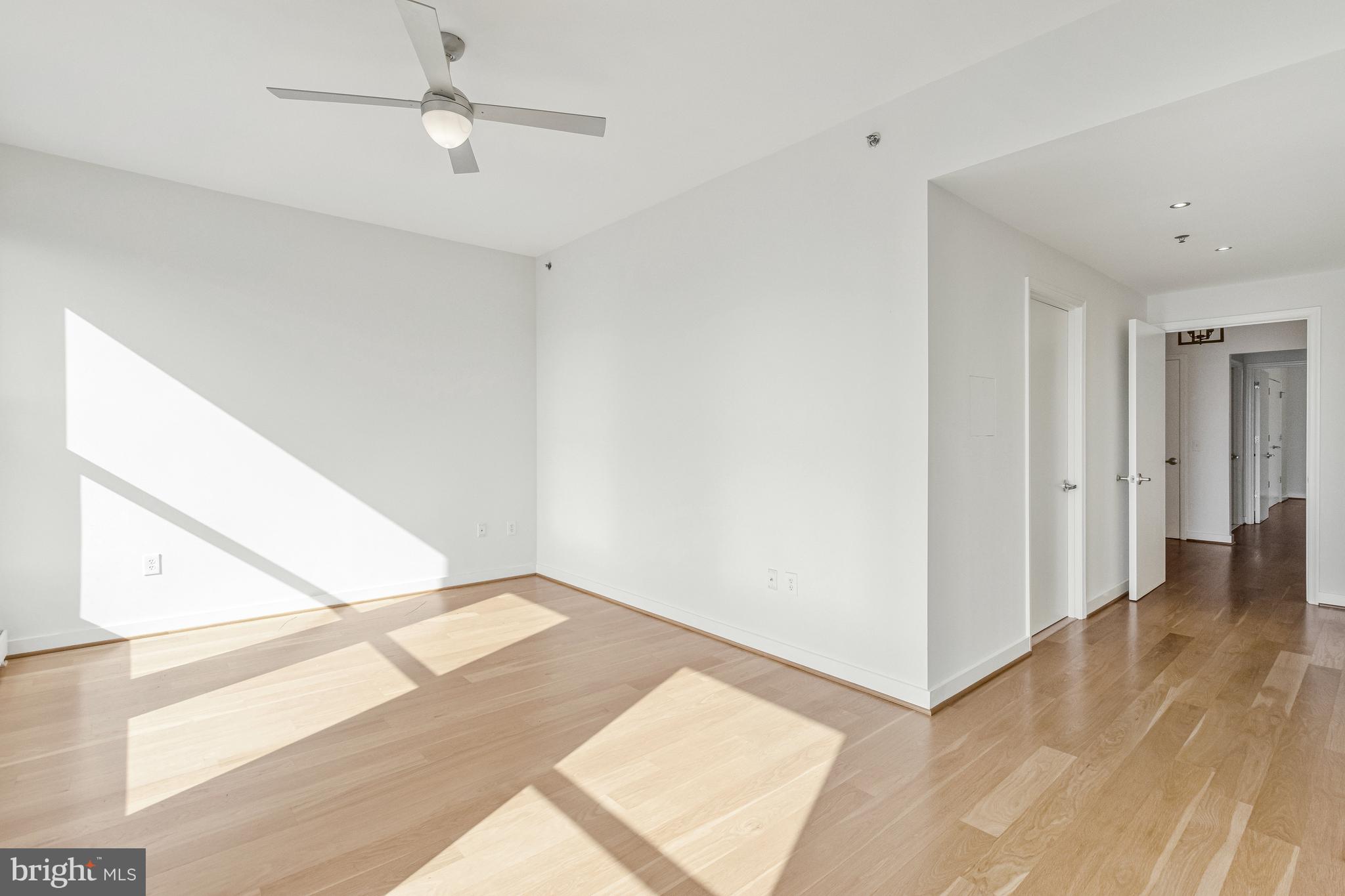675 E Street Northwest, Unit 900 Washington, DC 20004 - Photo 8 of 40 a view of an empty room with wooden floor