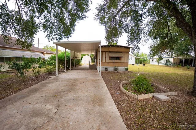 a view of a backyard with a garden and plants