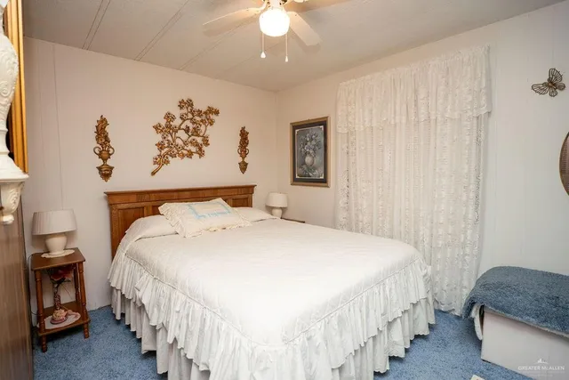 a bathroom with a granite countertop sink and a toilet