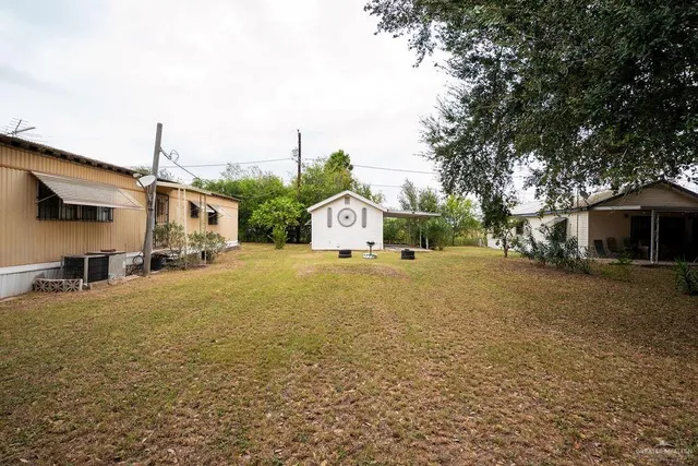 a view of swimming pool with outdoor seating and yard
