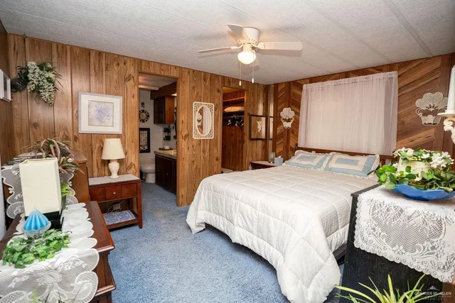 a bedroom with a bed and a mirror