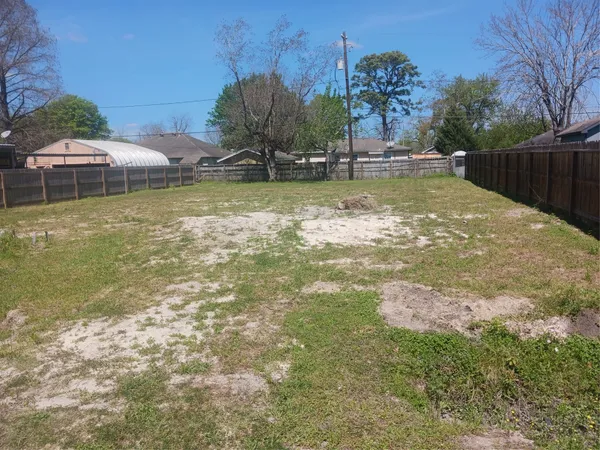 a view of a swimming pool with a lawn chairs under an umbrella