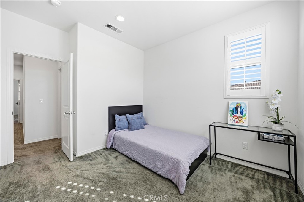 11175 Legion Loop, Unit 110 El Monte, CA 91731 - Photo 14 of 23 a bedroom with a bed and a window