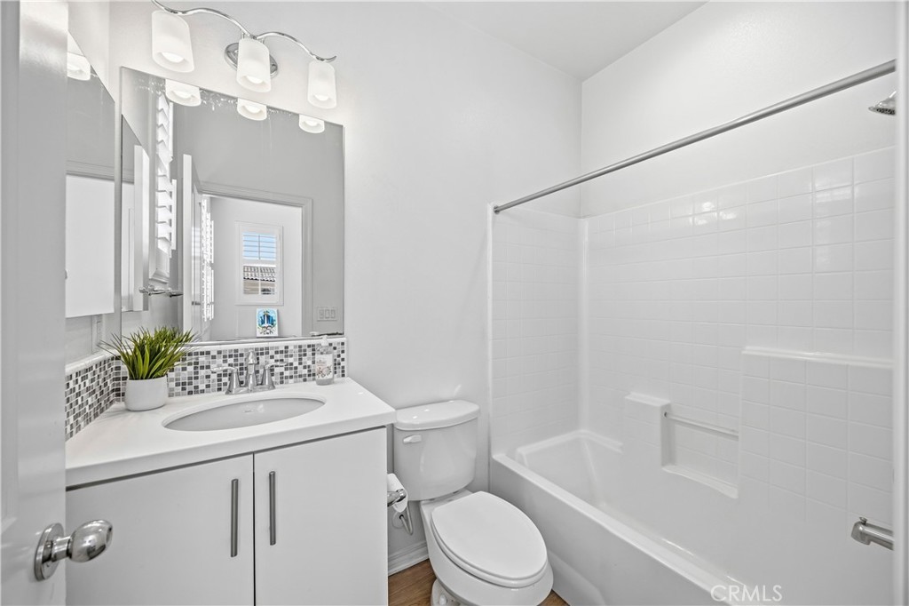 11175 Legion Loop, Unit 110 El Monte, CA 91731 - Photo 17 of 23 a bathroom with a sink a toilet a mirror a vanity and shower