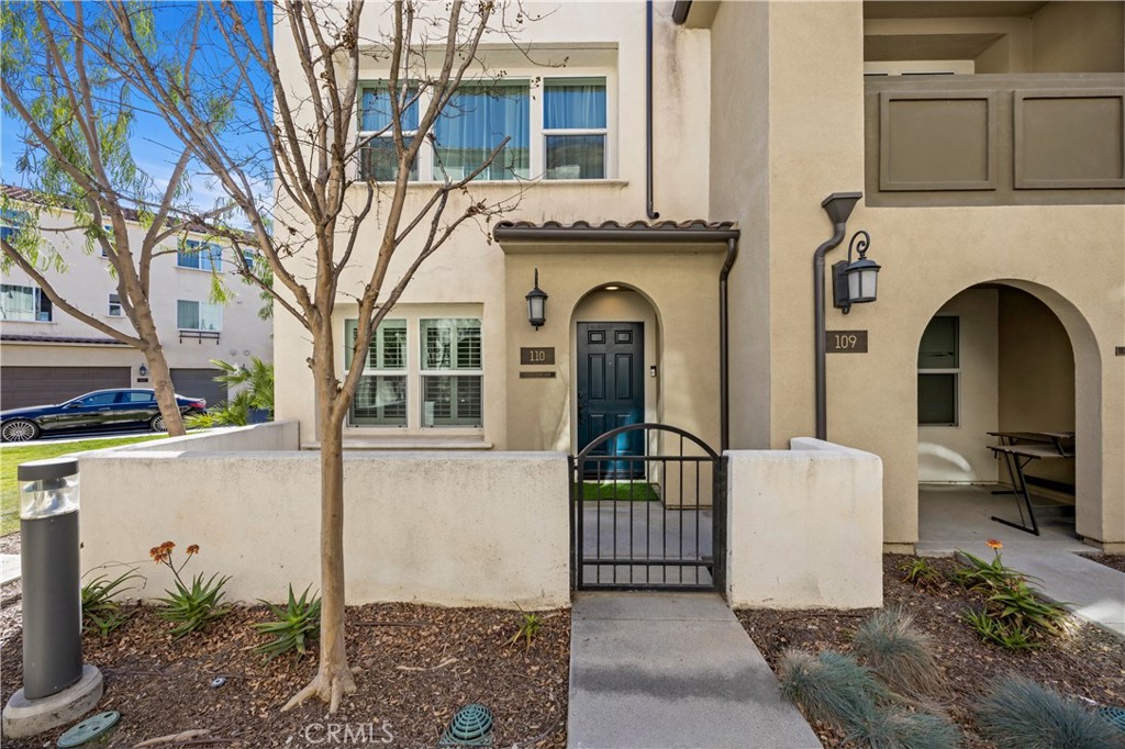 11175 Legion Loop, Unit 110 El Monte, CA 91731 - Photo 2 of 23 a front view of a house with garden