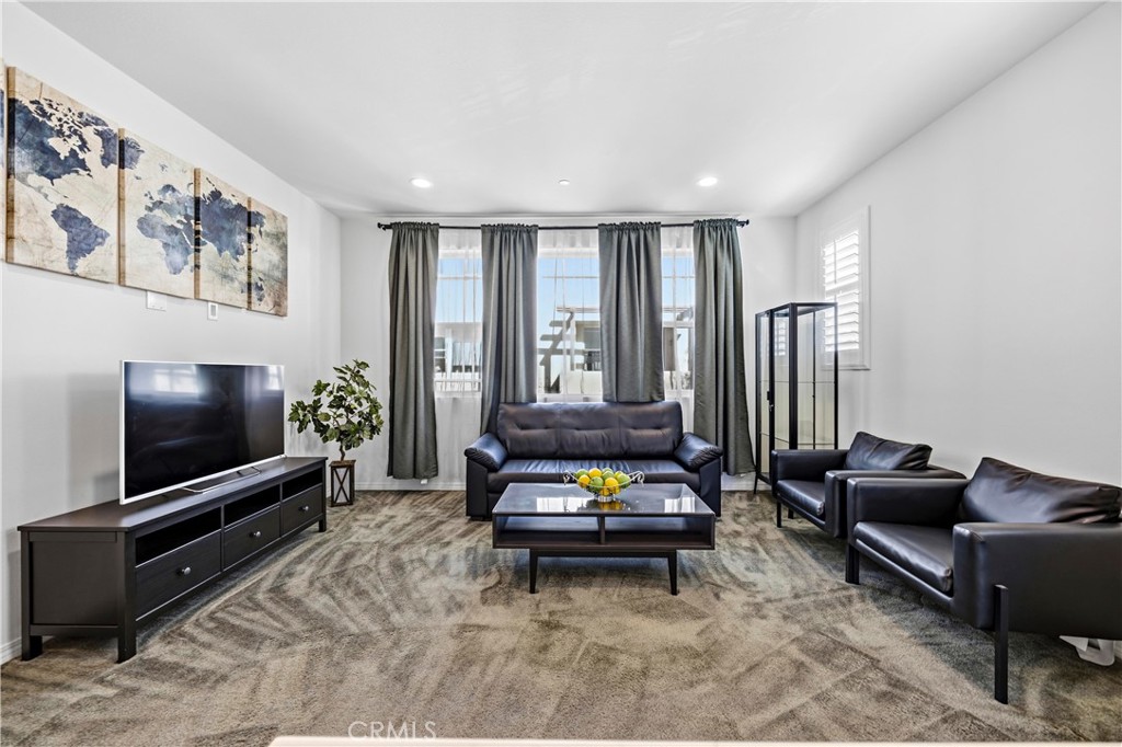 11175 Legion Loop, Unit 110 El Monte, CA 91731 - Photo 10 of 23 a living room with furniture and a flat screen tv