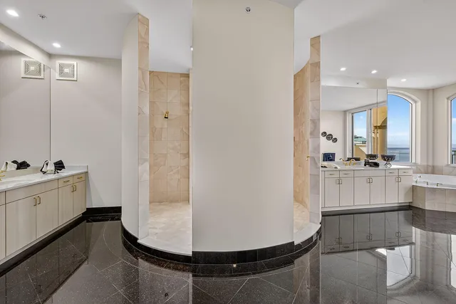 a large kitchen with kitchen island a sink appliances and a large window