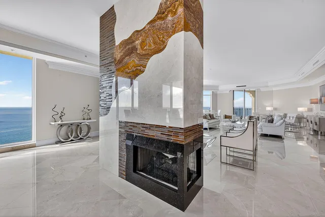 a living room with furniture and large windows