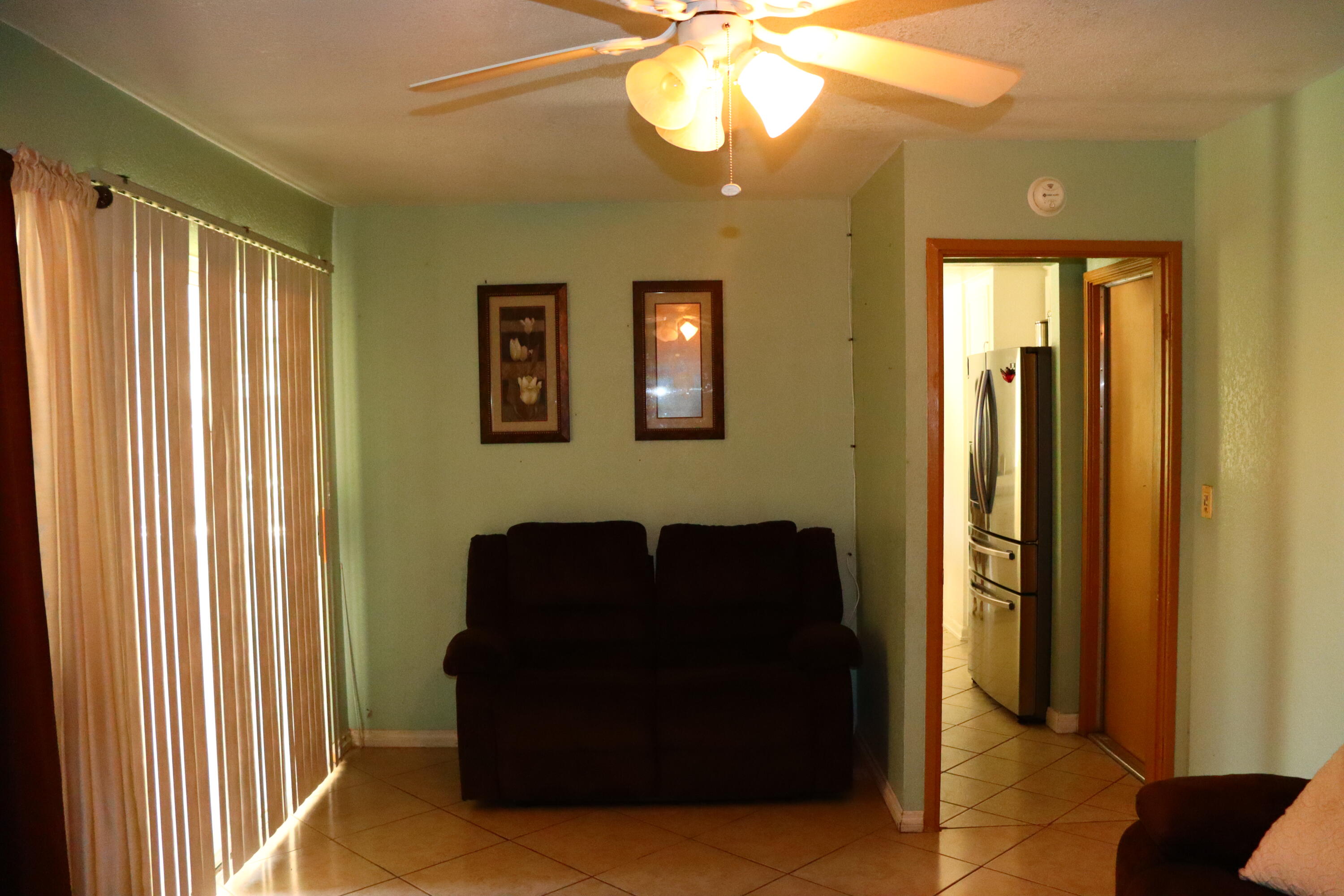 5009 East Ave R 11 Palmdale, CA 93552 - Photo 11 of 23 a view of a livingroom with furniture and windows