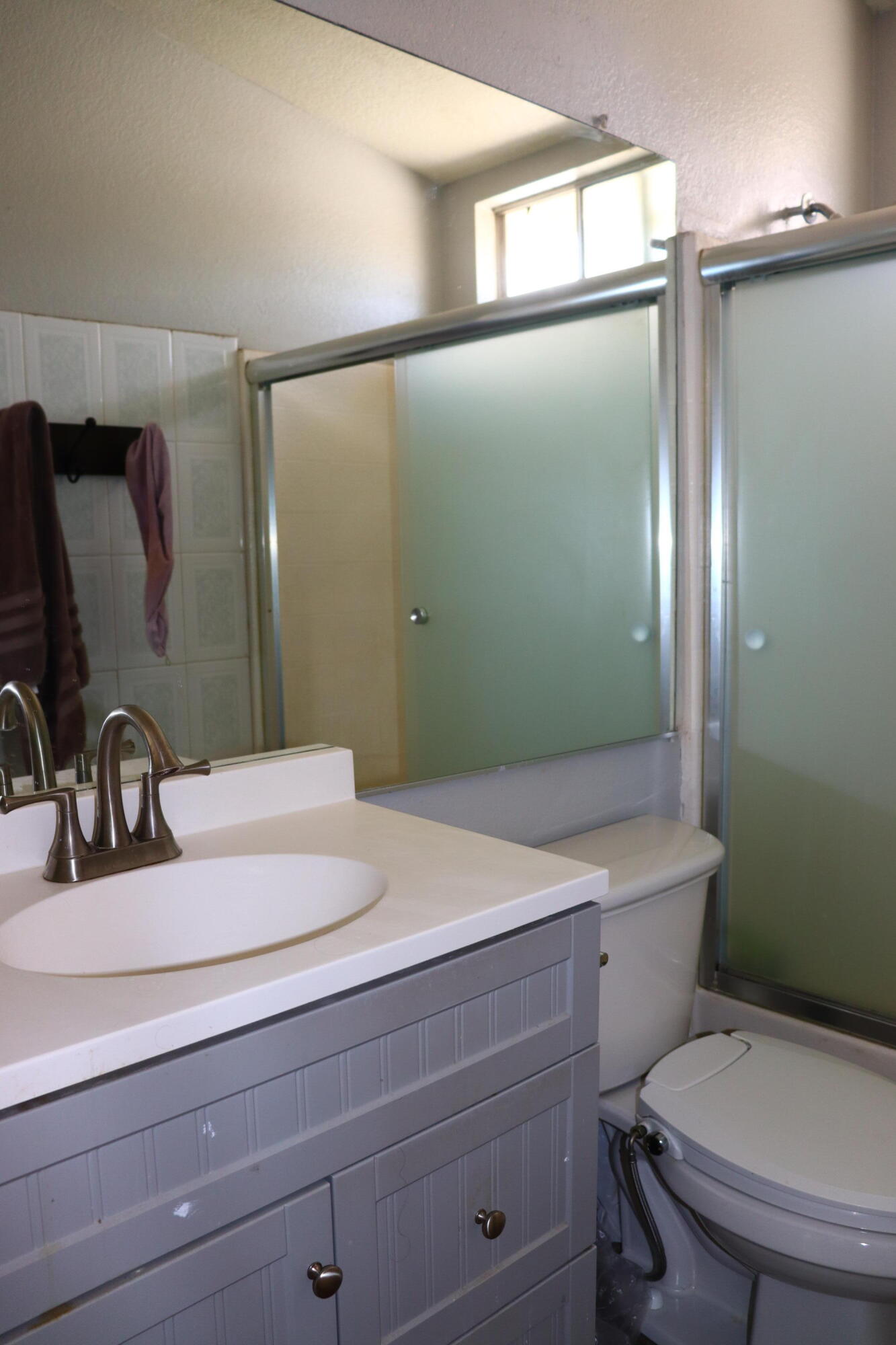 5009 East Ave R 11 Palmdale, CA 93552 - Photo 15 of 23 a bathroom with a sink a toilet and mirror