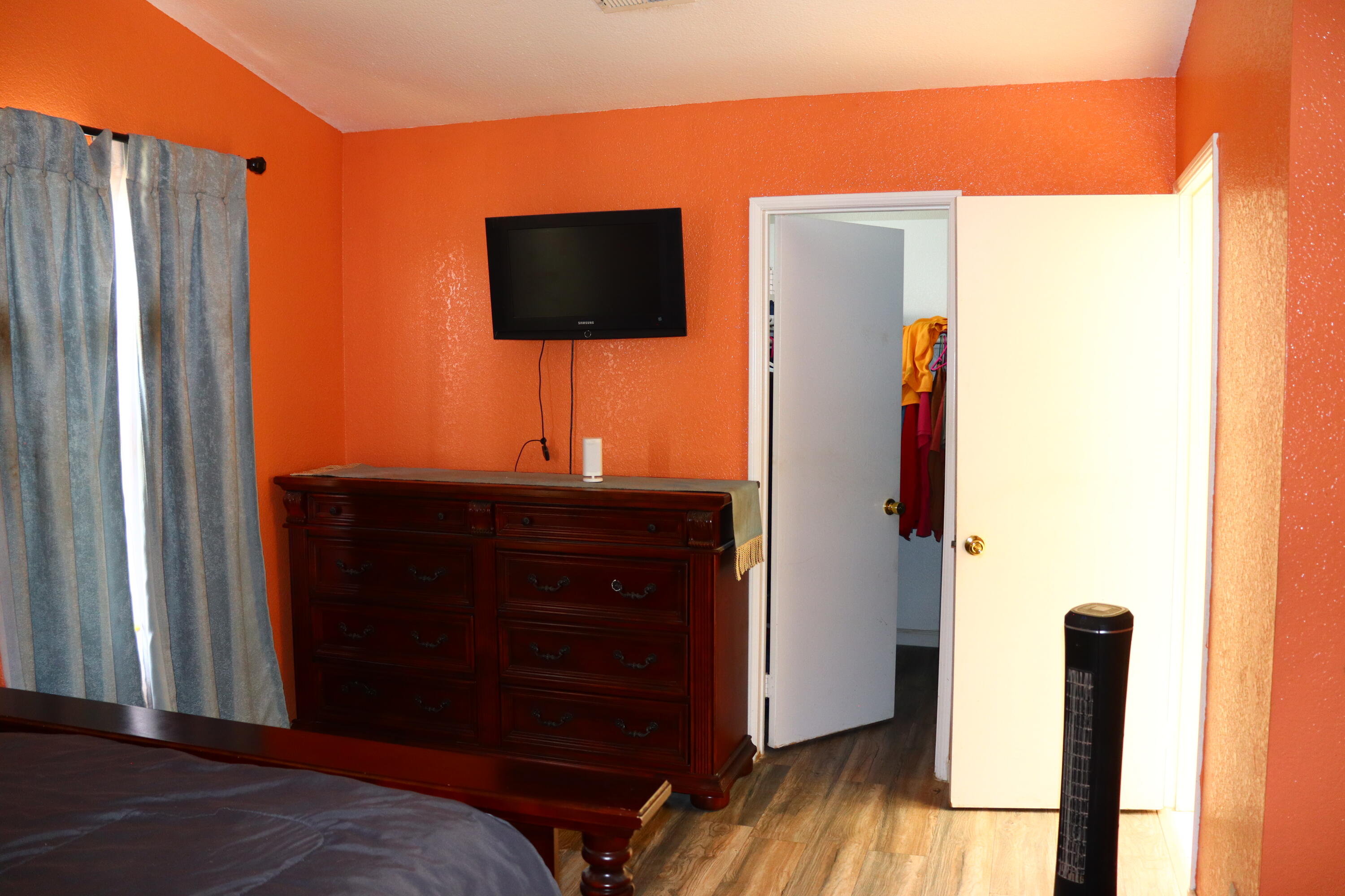 5009 East Ave R 11 Palmdale, CA 93552 - Photo 17 of 23 a bedroom with a bed and a flat screen tv