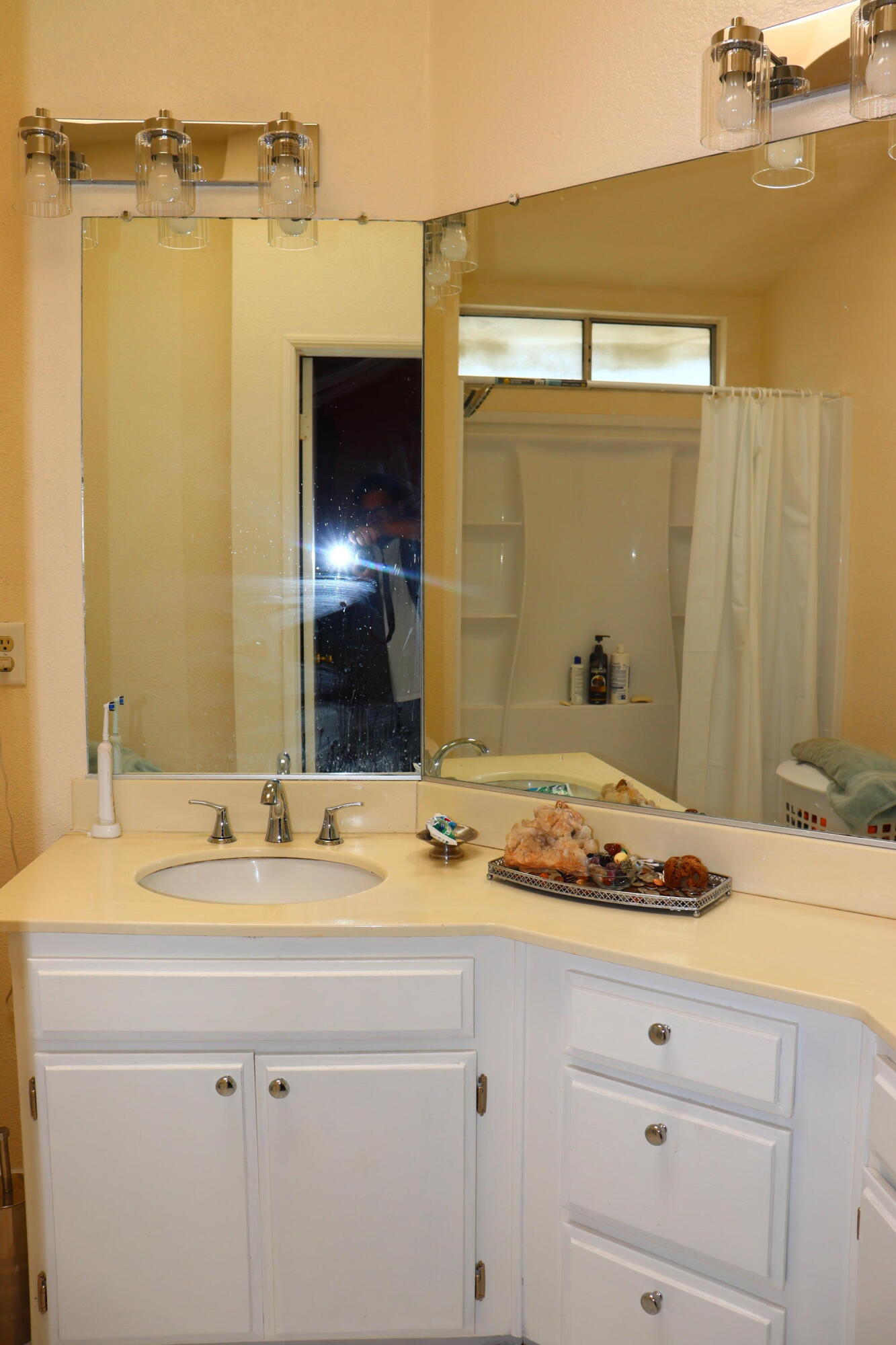 5009 East Ave R 11 Palmdale, CA 93552 - Photo 19 of 23 a bathroom with a sink and a mirror