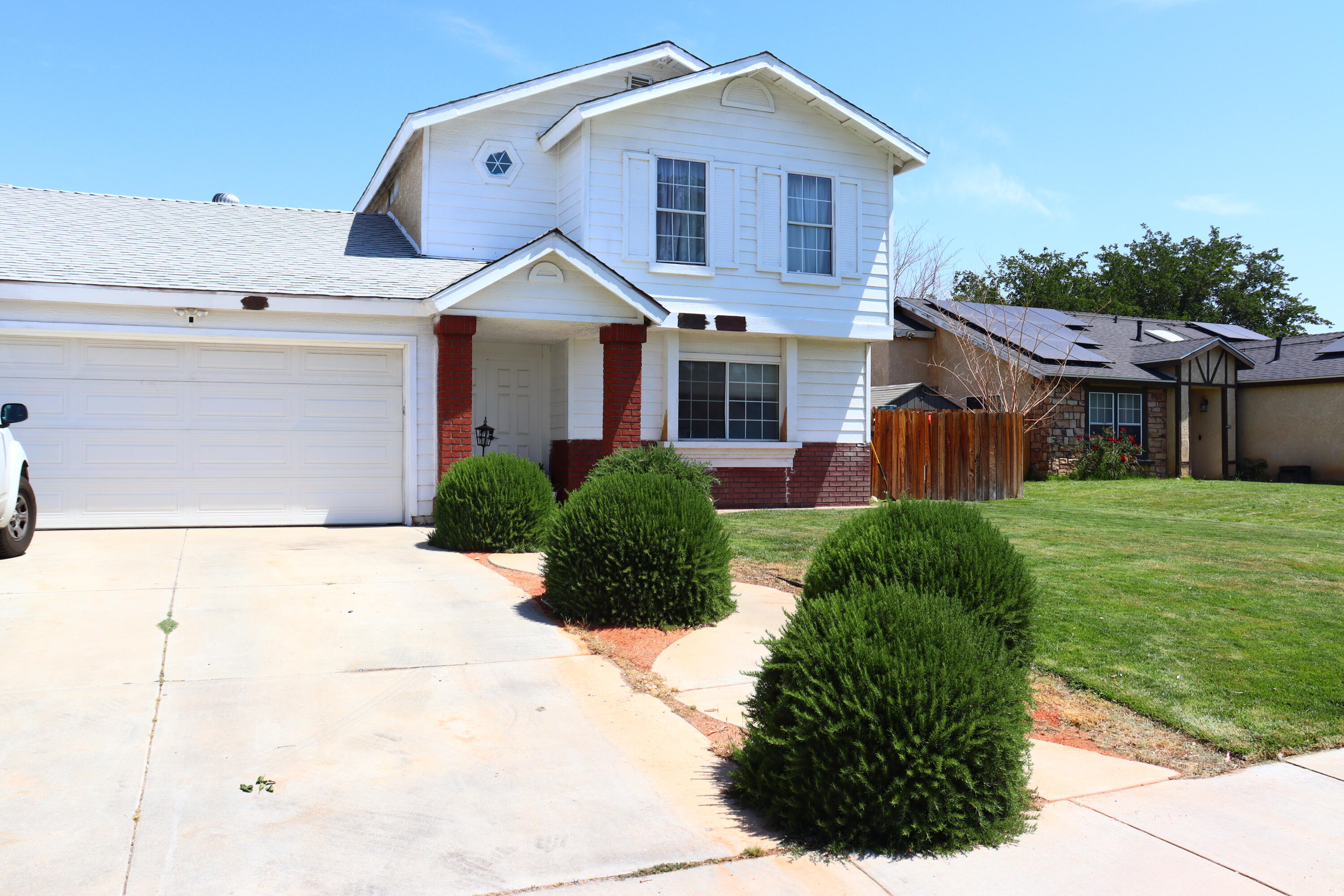 5009 East Ave R 11 Palmdale, CA 93552 - Photo 2 of 23 a front view of a house with a yard