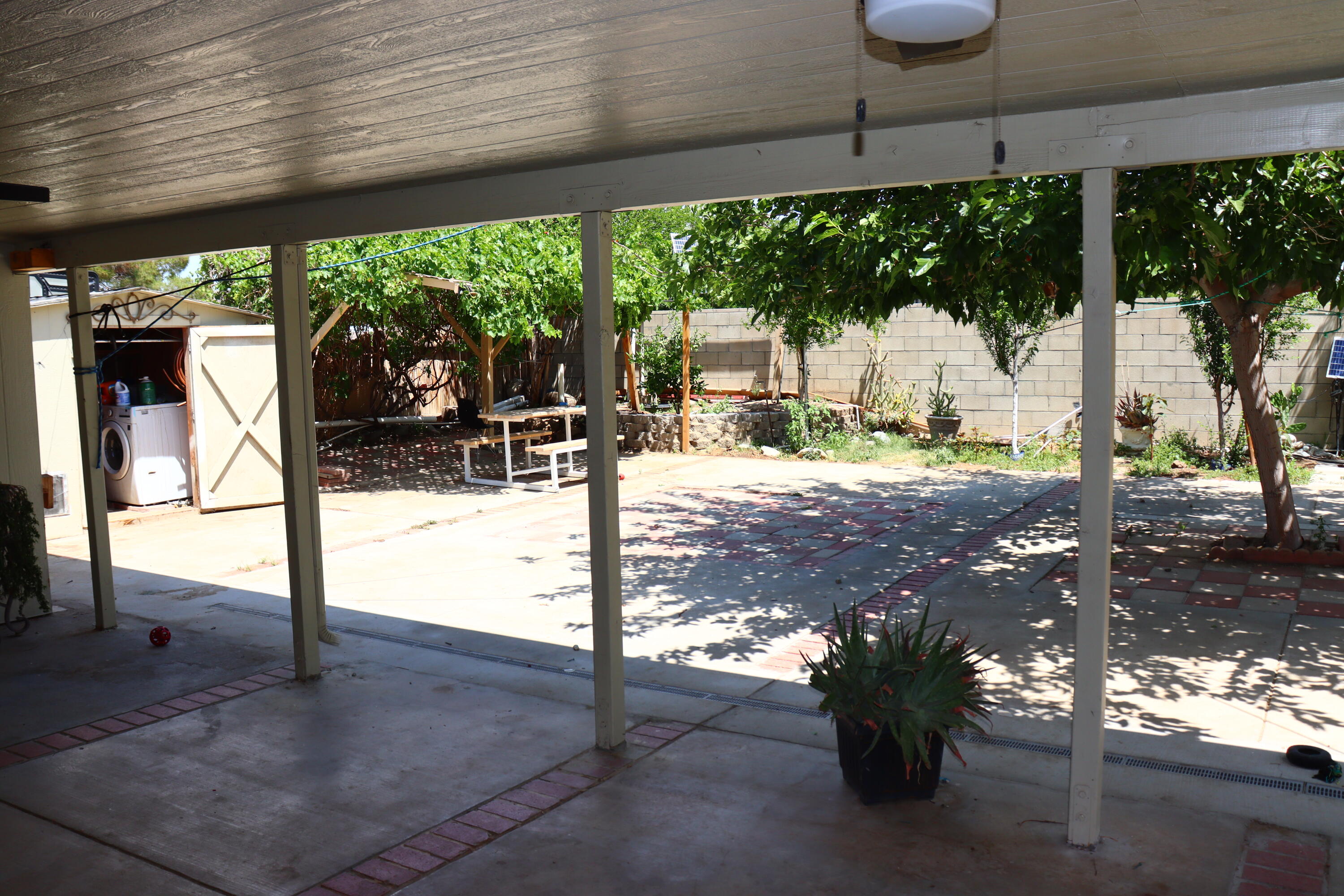 5009 East Ave R 11 Palmdale, CA 93552 - Photo 21 of 23 a view of a patio with a table chairs and a floor to ceiling window
