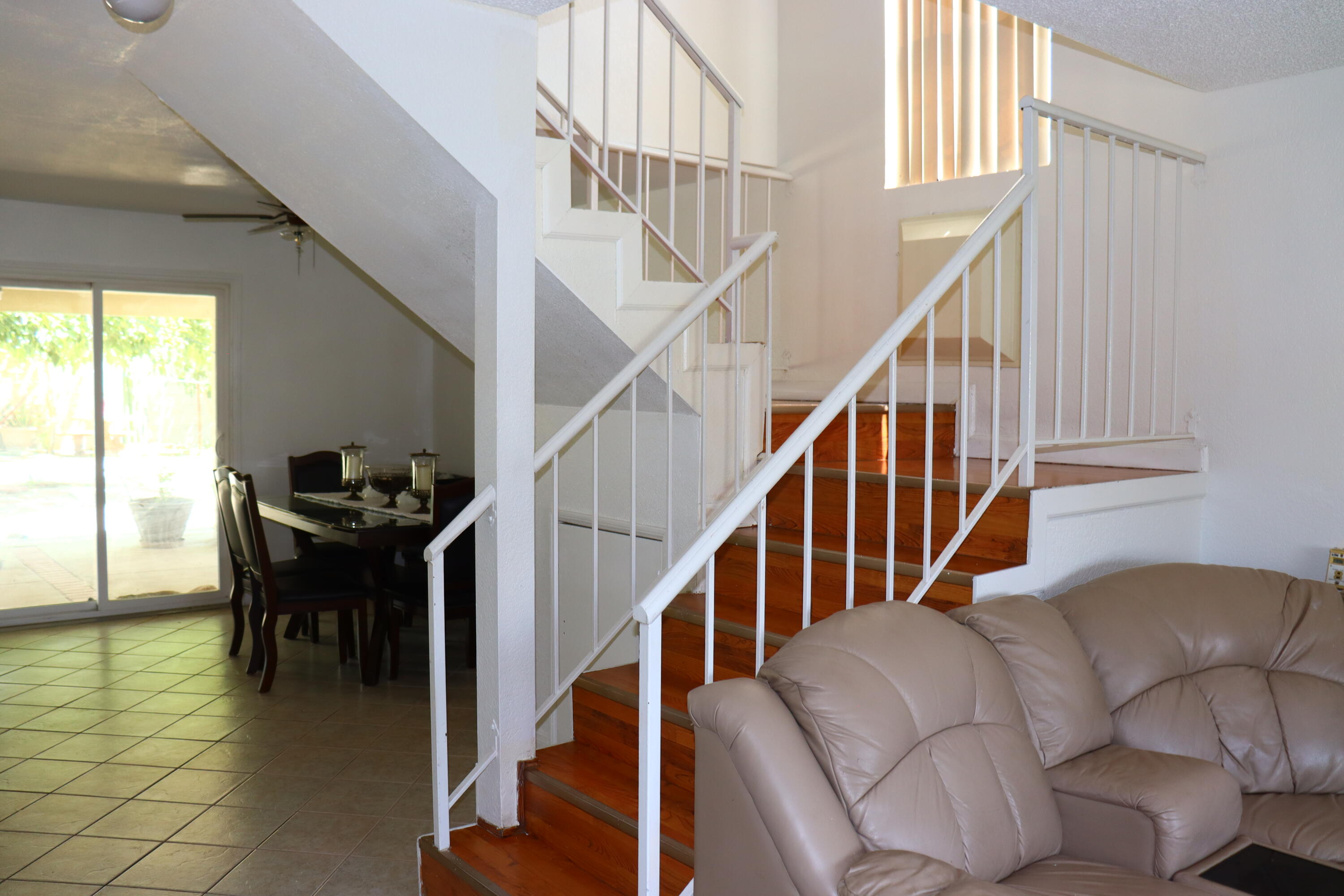 5009 East Ave R 11 Palmdale, CA 93552 - Photo 5 of 23 a dining room with furniture entryway and stairs