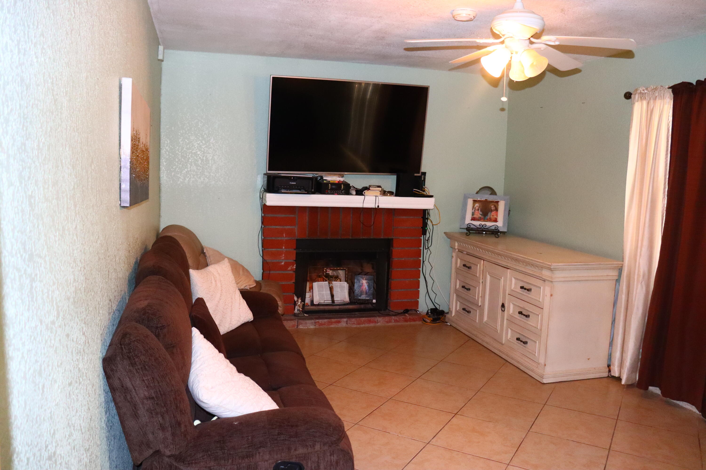 5009 East Ave R 11 Palmdale, CA 93552 - Photo 10 of 23 a living room with furniture and a fireplace