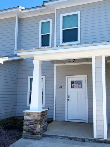 a view of house with wooden door and wooden door