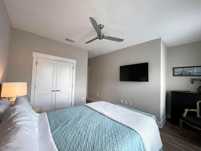 a bedroom with a bed and a flat screen tv