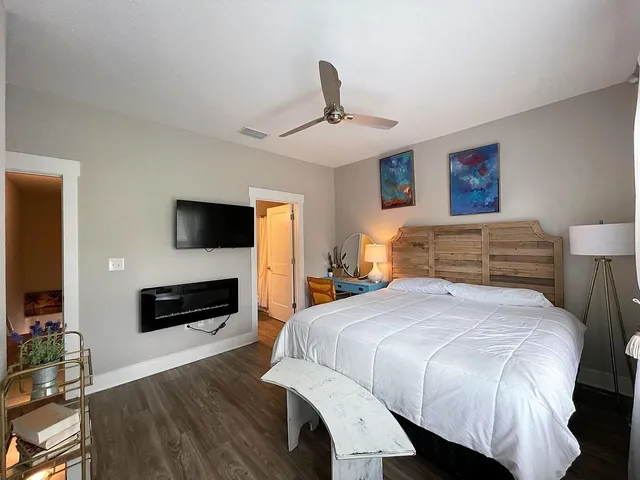 a bedroom with a bed and a flat screen tv